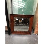 A BEVELLED GLASS RECTANGULAR MIRROR IN A 19th C. MAHOGANY FRAME. 51 x 44cms.