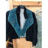 A VINTAGE BEADED GREEN STOLE TOGETHER WITH A BLACK VELVET JACKET, TWO PAIRS OF STOCKINGS AND A