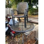 A MODERN PATIO TABLE WITH FOUR MATCHING CHAIRS