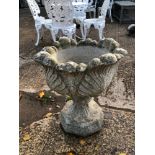 A COMPOSITE GARDEN URN ON STAND