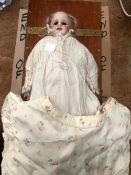 A BISQUE HEADED DOLL WITH FIXED OPEN EYES AND KID LEATHER LEGS. H 40cms.