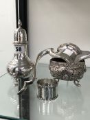 AN INDIAN SILVER PIERCED BOWL, A HALLMARKED CASTER, A CLARET JUG MOUNT AND A NAPKIN RING.