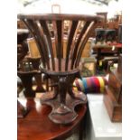 A VICTORIAN MAHOGANY PLANTER CRADLE SUPPORTED ON THREE DOLPHINS HEADS, THEIR TAILS ON A PLINTH