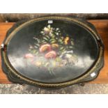 A TOLE TWO HANDLED TRAY PAINTED WITH FLOWERS ON A BLACK GROUND