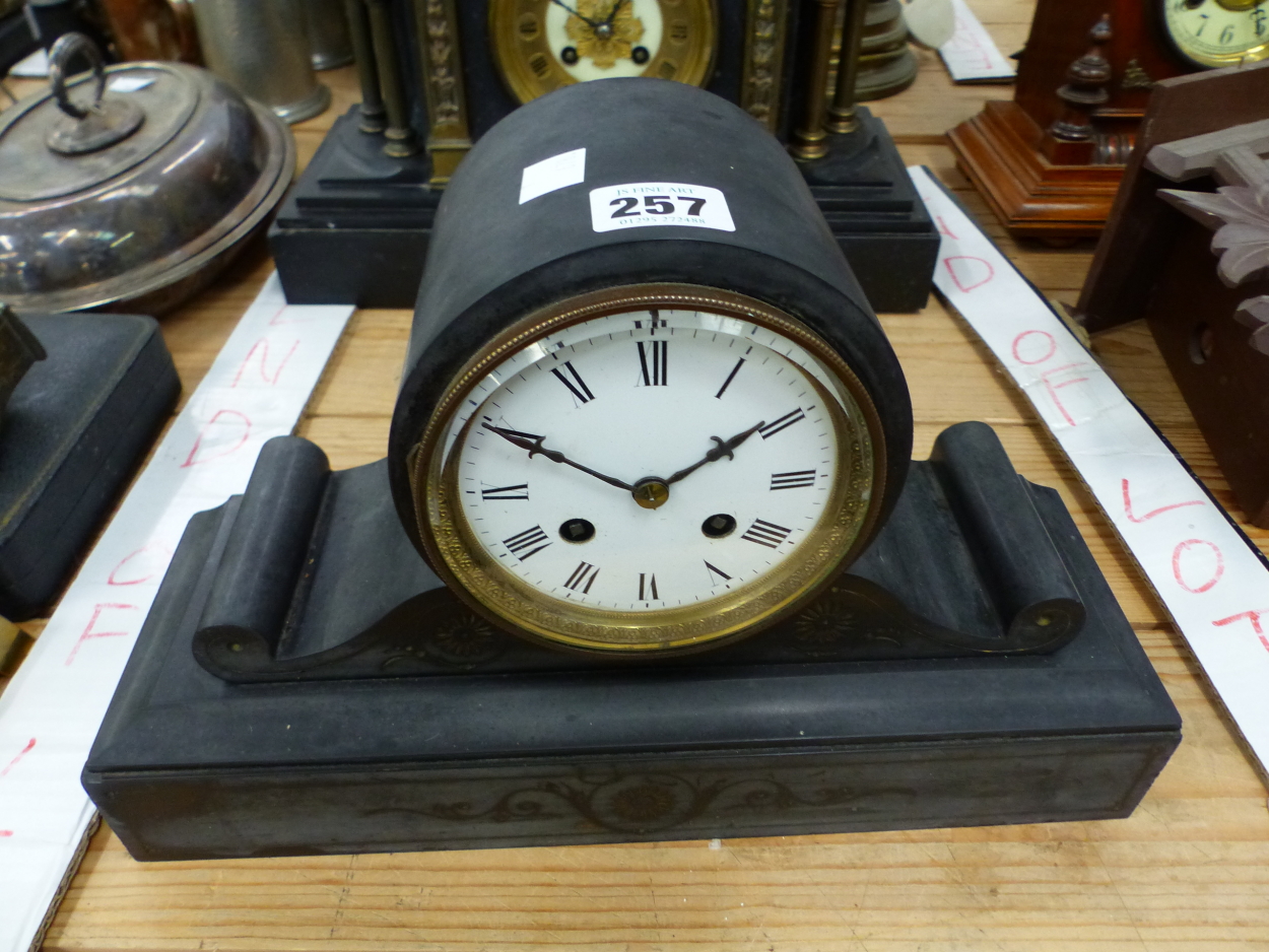 A VICTORIAN BLACK SLATE MANTEL CLOCK WITH WHITE ENAMEL DIAL