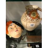 A CHARLOTTE RHEAD BURSLEY WARE JUG TOGETHER WITH A BESWICK WALL MASK OF A LADY WEARING A BERET