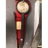 A BANJO WITH THE REMAINS OF ITS CASE