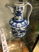 A CHINESE BLUE AND WHITE EWER PAINTED WITH A BAND OF FLOWERS, SIX CHARACTER MARK BELOW THE SPOUT