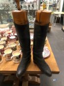 A PAIR OF BLACK RIDING BOOTS WITH THEIR TREES