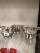 ONE HALLMARKED SILVER SAUCE BOAT, TWO CREAMERS AND A HALLMARKED SILVER FOOTED POSY BOWL.
