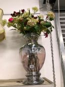 AN IRIDESCENT GLASS VASE OF FLOWERS