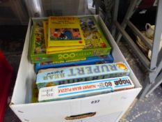 A COLLECTION OF RUPERT BEAR JIGSAW PUZZLES AND BOOKS ETC