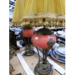 A PAIR OF TABLE LAMPS WITH TERRACOTTA COLOUR BUN SHAPED BOWLS SUPPORTED ON BRASS ARMS AND BASES
