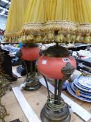 A PAIR OF TABLE LAMPS WITH TERRACOTTA COLOUR BUN SHAPED BOWLS SUPPORTED ON BRASS ARMS AND BASES