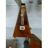 A VICTORIAN WALNUT METRONOME.