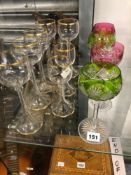FOUR CRANBERRY AND GREEN OVERLAY WINE GLASSES TOGETHER WITH SEVEN WINE GLASSES WITH GILT LINE
