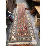 A ORIENTAL RUNNER OF CAUCASIAN DESIGN. 331 x 89cms TOGETHER WITH A SMALL PERSIAN TRIBAL RUG (2)