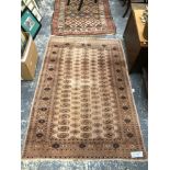 AN ORIENTAL RUG OF BOKHARA DESIGN. 185 x 127cms