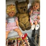 TWO VINTAGE PLASTIC DOLLS TOGETHER WITH A TEDDY BEAR AND A COLLECTION OF TOY CARS IN DISPLAY CASE.