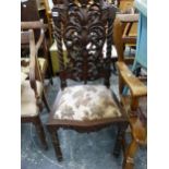 A CARVED HARDWOOD ARMCHAIR AND SIMILAR SIDE CHAIR