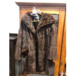 A VINTAGE FUR COAT BY SMITH AND SONS