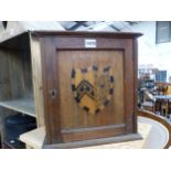 A VINTAGE OAK SMOKERS CABINET WITH INLAID ARMORIAL CREST