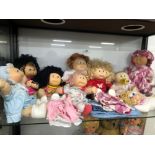 A COLLECTION OF NINE VINTAGE CABBAGE PATCH KIDS DOLLS WITH SOME EXTRA CLOTHING.