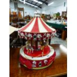 A DECORATIVE CHRISTMAS CAROUSEL ORNAMENT