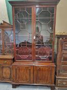 A GEORGIAN MAHOGANY DISPLAY CABINET, THE UPPER HALF WITH ASTRAGAL GLAZED DOORS OVER SHELVING THE