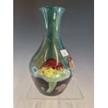 A WILLIAM MOORCROFT CLAREMONT PATTERN VASE SLIP TRAILED WITH COLOURFUL TOADSTOOLS ON A SEA GREEN
