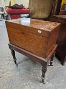 A EARLY 19th CENTURY PLUM PUDDING MAHOGANY CELLARETTE ON STAND, THE RECTANGULAR HINGED LID OVER