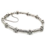 A 14ct WHITE GOLD HALLMARKED CLUSTER AND PANEL DIAMOND LINE BRACELET COMPLETE WITH SAFETY CHAIN.