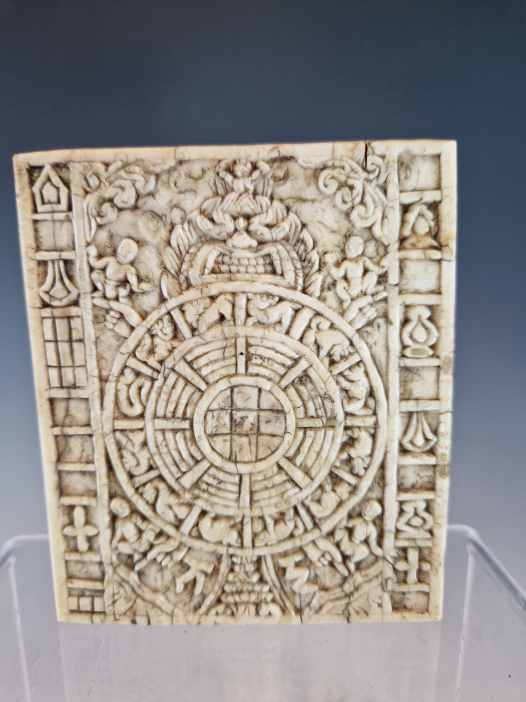 A TIBETAN ELEPHANT TOOTH PANEL CARVED WITH AN ASTROLOGICAL CALENDAR OR KALACHAKRA, THE WHEEL