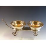 AN ANTIQUE WINE CADDY WITH A PAIR OF SILVER WINE COASTERS ON A FOUR WHEELED TROLLEY BY C P,