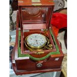 A RUSSIAN MARINE CHRONOMETER WITHIN DOUBLE WOODEN CASES OF MAHOGANY STAINED WOOD, THE DIAL BEZEL.