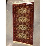 AN ORIENTAL RUG OF PERSIAN DESIGN. 194 x 106cms