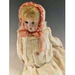 AN EICHORN AND SOHN BISQUE HEADED DOLL. H 42cms. TOGETHER WITH A SIMON AND HALBIG BISQUE HEADED