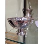 A DUCHESS OF SUTHERLANDS CRIPPLE GUILD PLATE ON COPPER FOOTED BOWL WORKED WITH A BAND OF ROSETTES.