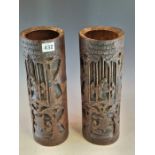 A PAIR OF CHINESE BAMBOO BRUSH POTS CARVED WITH SCHOLARS IN A BAMBOO GROVES ABOVE MEN SAILING BELOW.