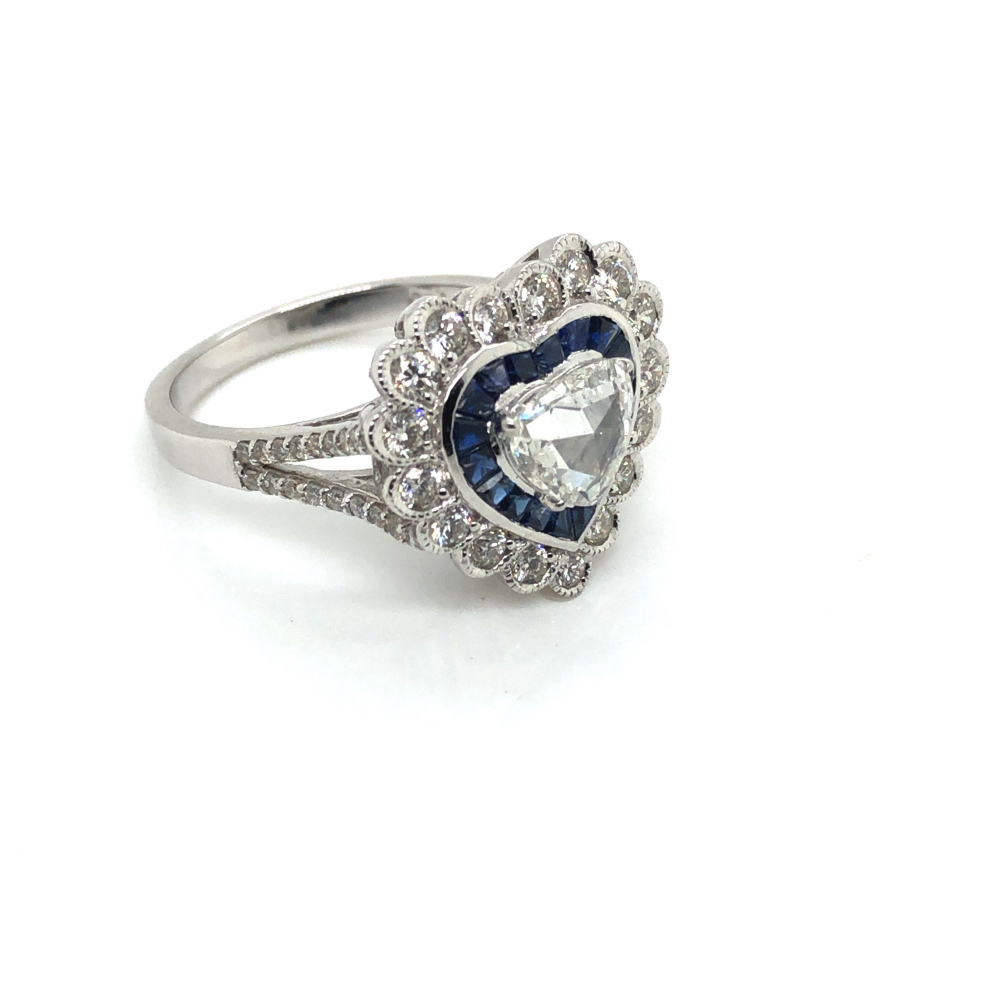 A SAPPHIRE AND DIAMOND HEART SHAPE CLUSTER RING. THE CENTRAL DIAMOND A FANCY CUT SURROUNDED BY A - Image 3 of 3