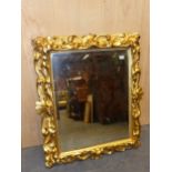 AN ITALIAN BEVELLED GLASS RECTANGULAR MIRROR IN A GILT WOOD FRAME CARVED WITH ANTHEMION MOTIFS AND