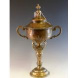 A SILVER TWO HANDLED TROPHY CUP AND COVER BY CHARLES STUART HARRIS, LONDON 1938, THE BOWL