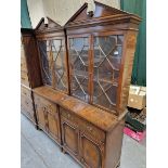 A PAIR OF MODERN MAHOGANY DISPLAY CABINETS, EACH WITH A BROKEN PEDIMENT ABOVE GLAZED DOORS ENCLOSING