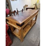 A BUTCHERS CHOPPING BLOCK TABLE, THE RECTANGULAR TOP ABOVE A POT BOARD JOINING LEGS OF MASSIVE SQU