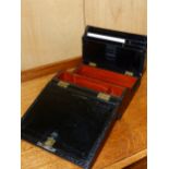 A VICTORIAN PARKINS AND GOTTO DICED BLACK LEATHER WRITING SLOPE WITH FOLD UP STATIONARY