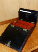 A VICTORIAN PARKINS AND GOTTO DICED BLACK LEATHER WRITING SLOPE WITH FOLD UP STATIONARY
