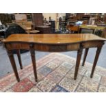 AN ADAM STYLE MAHOGANY SERVING TABLE, CENTRE OF THE SERPENTINE APRON WITH A CARVED PANEL OF TWO EAGL