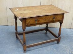 A 18th C. ELM TABLE WITH A SINGLE LONG DRAWER ABOVE BALUSTER LEGS JOINED BY STRETCHERS ABOVE THE