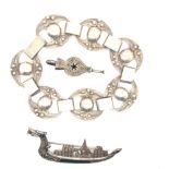 A SIAM SILVER NIELLO DRAGON BOAT BROOCH, TOGETHER WITH AN EASTERN SILVER FILIGREE BRACELET, AND A