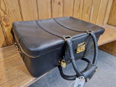 A SALVATORE FERRAGAMO BLACK LUGGAGE CASE TOGETHER WITH A BROWN LEATHER TRAVEL BAG
